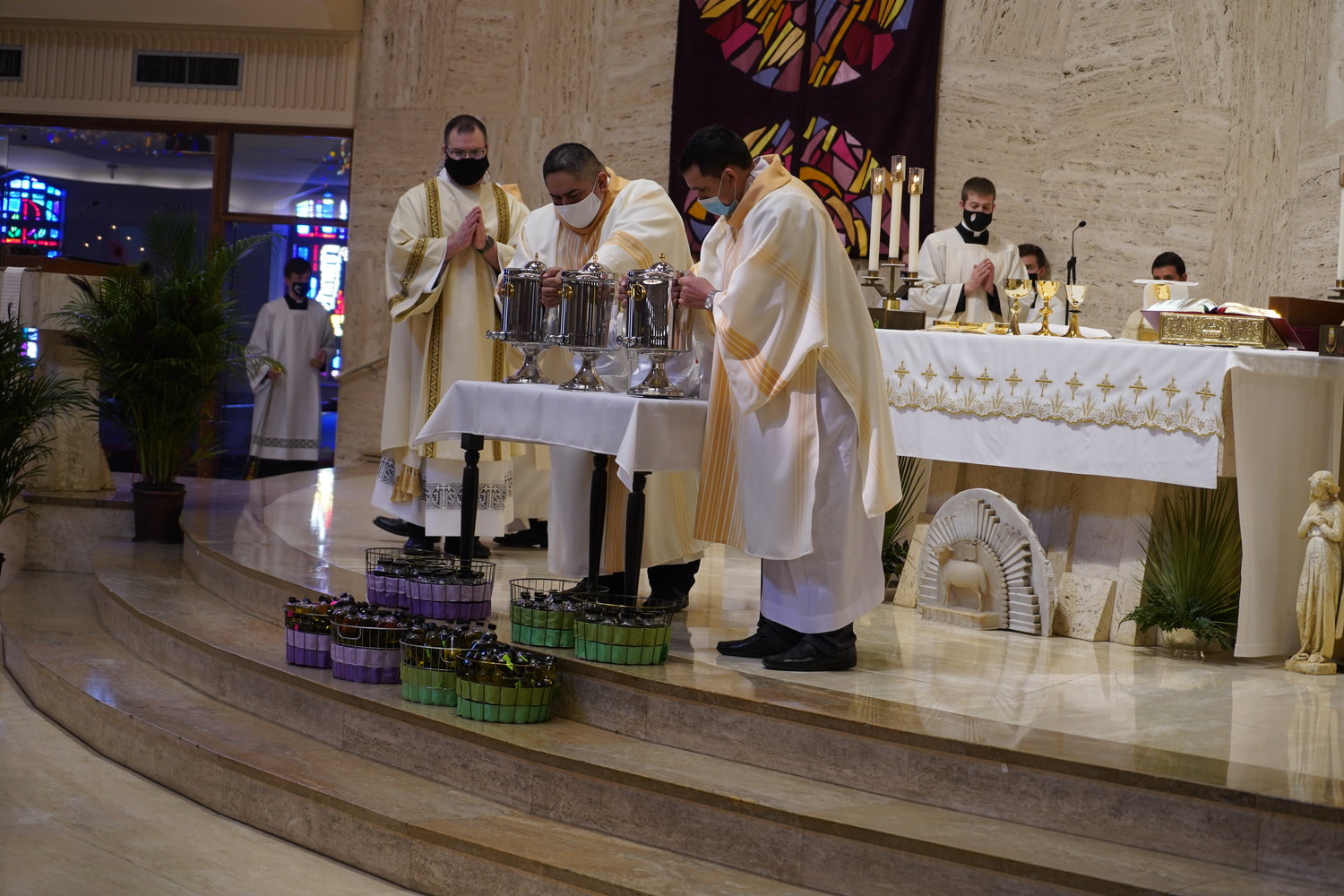 Rev. Mr. Derek Hooper observes Deacon Louis Reyes and Deacon Santos Rubio presenting the Oil of Catechumens and the Oil of the Sick during the Chrism Mass March 30 in the Cathedral of St. Joseph.